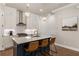 Kitchen with pendant lights, stainless steel appliances, gas range, kitchen island, and bar stool seating at 520 Clover Ln, Alpharetta, GA 30009
