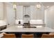 Kitchen island with pendant lights, stainless steel appliances, gas range, and ample storage at 520 Clover Ln, Alpharetta, GA 30009
