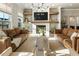 Well-lit living room with a fireplace, large windows, and comfortable seating arrangements at 520 Clover Ln, Alpharetta, GA 30009