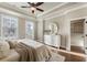 Bright main bedroom features a ceiling fan, large windows, and a door leading to a balcony at 520 Clover Ln, Alpharetta, GA 30009
