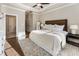 Bright main bedroom featuring a king bed, hardwood floors, and natural light at 520 Clover Ln, Alpharetta, GA 30009