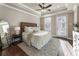 Spacious main bedroom with hardwood floors, tray ceiling, and a king size bed at 520 Clover Ln, Alpharetta, GA 30009