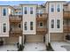 A row of modern townhomes, each featuring a private balcony, and garages at 520 Clover Ln, Alpharetta, GA 30009