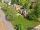 An elevated view of a home on a lush green lot showing mature trees under a partially cloudy sky at 5815 P.W.A. Dr, Cumming, GA 30041