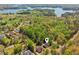A distant aerial shot captures a home in a lush, green area, with views of a large lake and surrounding trees at 5815 P.W.A. Dr, Cumming, GA 30041