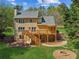 Two-story home featuring large deck and patio with a fire pit in the lush backyard at 5815 P.W.A. Dr, Cumming, GA 30041