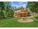 Backyard with a wooden deck, stone walkway, and outdoor brick fire pit at 5815 P.W.A. Dr, Cumming, GA 30041