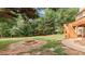 Backyard with a brick fire pit, stone walkway, a wooden deck and mature trees at 5815 P.W.A. Dr, Cumming, GA 30041