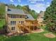 Backyard of the home with a wooden deck, stone walkway, and fire pit at 5815 P.W.A. Dr, Cumming, GA 30041