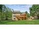 Exterior view of a two-story home featuring deck, patio and backyard with a fire pit at 5815 P.W.A. Dr, Cumming, GA 30041