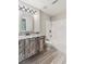 Well-lit bathroom with wood-styled vanity, granite countertops, tile floors, and a shower-tub combo at 5815 P.W.A. Dr, Cumming, GA 30041