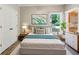 Cozy bedroom features plush carpeting, a comfortable bed, and bright natural light at 5815 P.W.A. Dr, Cumming, GA 30041