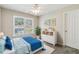 Bright bedroom with a ceiling fan, a large window with a view, and a charming blue comforter at 5815 P.W.A. Dr, Cumming, GA 30041