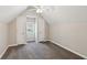 Carpeted bedroom featuring a ceiling fan and two closets with a window in between at 5815 P.W.A. Dr, Cumming, GA 30041