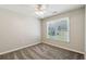 Comfortable carpeted bedroom with a ceiling fan and a large window for natural light at 5815 P.W.A. Dr, Cumming, GA 30041