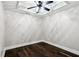 Modern bedroom with hardwood floors, ceiling fan, and tray ceiling at 5815 P.W.A. Dr, Cumming, GA 30041