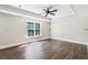 Primary bedroom features a tray ceiling, ceiling fan, and hardwood floors at 5815 P.W.A. Dr, Cumming, GA 30041