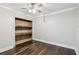 Bedroom with hardwood floors, ceiling fan, and a closet with shelving at 5815 P.W.A. Dr, Cumming, GA 30041