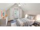 Cozy bedroom with neutral tones, featuring a ceiling fan and dual closets flanking a bright window at 5815 P.W.A. Dr, Cumming, GA 30041