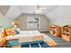 Colorful bedroom with a ceiling fan, and window featuring a bed with many pillows and toy storage at 5815 P.W.A. Dr, Cumming, GA 30041