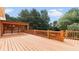 Inviting wooden deck area with a covered dining space, ample seating, and scenic backyard views at 5815 P.W.A. Dr, Cumming, GA 30041