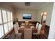 Dining room featuring wood floors, neutral walls, a large window, and a dining table for six at 5815 P.W.A. Dr, Cumming, GA 30041