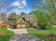 Traditional two-story home with manicured lawn and a driveway leading to a three-car garage at 5815 P.W.A. Dr, Cumming, GA 30041