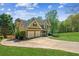 Attractive two-story home showcasing a manicured lawn, complemented by a curved driveway leading to an attached two-car garage at 5815 P.W.A. Dr, Cumming, GA 30041
