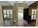 Bright foyer with wood floors and views into the rooms with large windows flanking the door at 5815 P.W.A. Dr, Cumming, GA 30041
