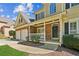 Inviting front porch with stone accents, a white railing, a black front door, and well-maintained landscaping at 5815 P.W.A. Dr, Cumming, GA 30041