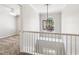Bright hallway featuring a modern chandelier and views into a carpeted bedroom at 5815 P.W.A. Dr, Cumming, GA 30041