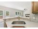 Kitchen with marble countertops and an open view into the living room at 5815 P.W.A. Dr, Cumming, GA 30041