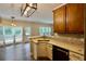 Bright kitchen featuring stainless appliances, a corner sink, and a view to the outdoor deck and yard at 5815 P.W.A. Dr, Cumming, GA 30041