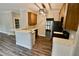 Updated kitchen with wooden cabinets, breakfast bar, and view into adjacent living space at 5815 P.W.A. Dr, Cumming, GA 30041