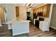 Modern kitchen with stylish breakfast bar, wooden cabinets, stainless steel appliances and wood-look flooring at 5815 P.W.A. Dr, Cumming, GA 30041