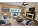 Bright living room features a fireplace, natural light and comfortable seating at 5815 P.W.A. Dr, Cumming, GA 30041