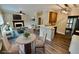 Staged open-concept living and dining area, featuring wood floors, fireplace and modern decor at 5815 P.W.A. Dr, Cumming, GA 30041