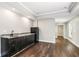 Spacious living room featuring hardwood floors, a wet bar with granite countertops, and a mini fridge at 5815 P.W.A. Dr, Cumming, GA 30041
