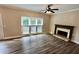 Bright living room featuring a brick fireplace and large windows, perfect for cozy gatherings at 5815 P.W.A. Dr, Cumming, GA 30041
