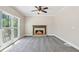 Open living room area with gray carpet and a fireplace at 5815 P.W.A. Dr, Cumming, GA 30041
