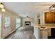 Open floor plan combines kitchen and living room with a fireplace, hardwood floors, and access to the backyard at 5815 P.W.A. Dr, Cumming, GA 30041
