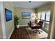 Home office featuring wood floors, neutral walls, a large window, and classic decor at 5815 P.W.A. Dr, Cumming, GA 30041