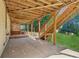 View of covered patio with staircase leading up to deck, and view of backyard at 5815 P.W.A. Dr, Cumming, GA 30041