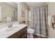 Bathroom featuring a decorative shower curtain, vanity with sink, and a framed mirror at 67 Narrowleaf Ln, Dallas, GA 30157