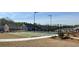 Community outdoor recreational area including bocce ball and tennis courts surrounded by lush landscaping on a clear day at 67 Narrowleaf Ln, Dallas, GA 30157