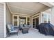 Covered patio with comfortable seating, a fire pit table, and a grill at 67 Narrowleaf Ln, Dallas, GA 30157