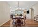 Open dining room with hardwood floors and a traditional wooden table, seamlessly connected to the living area at 67 Narrowleaf Ln, Dallas, GA 30157
