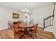 Cozy dining room featuring hardwood floors, wooden table and chairs, with a view of the staircase at 67 Narrowleaf Ln, Dallas, GA 30157