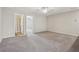 Large empty room with neutral carpet, two doorways, and potential for customization at 67 Narrowleaf Ln, Dallas, GA 30157
