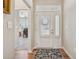 Bright entryway featuring hardwood floors, white front door with sidelight, and decorative rug at 67 Narrowleaf Ln, Dallas, GA 30157